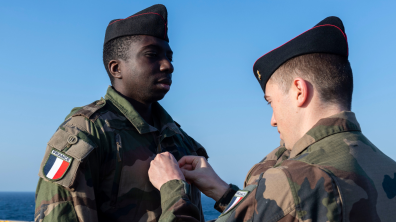  Le capitaine Thomas remet ses galons au sapeur de 1ère classe Samba.